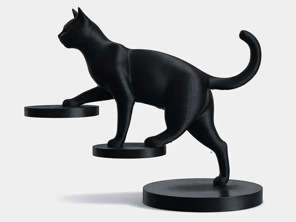 Inspiração: Escultura preta de gato com pequenos suportes